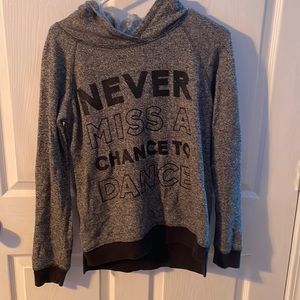 Black Hoodie. Quote “Never miss a chance to dance”. Size 14/16 in juniors